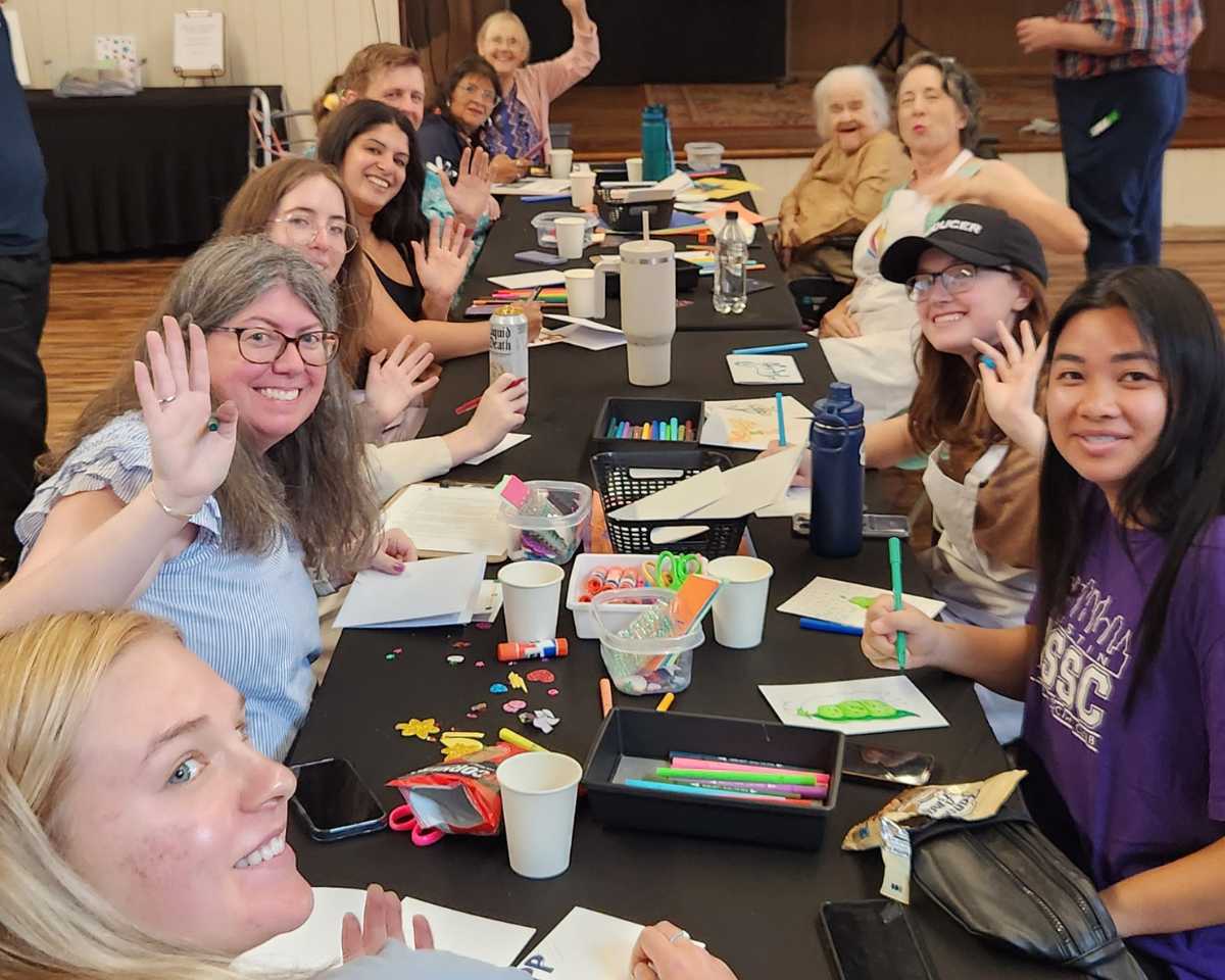 Employees at a Hello by Hand workplace activation making handmade cards.