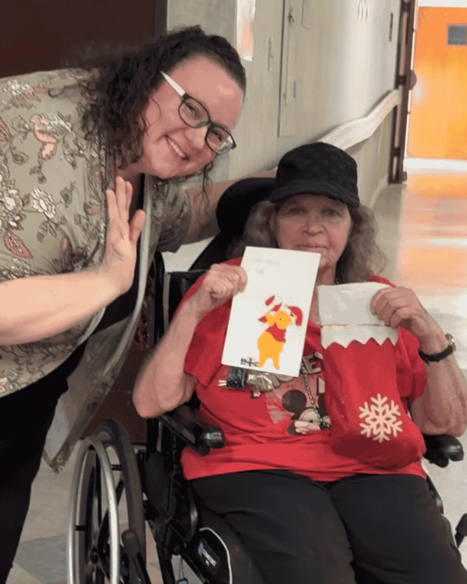 Linda, a resident at an Austin nursing home, receiving a handmade card on Christmas Eve