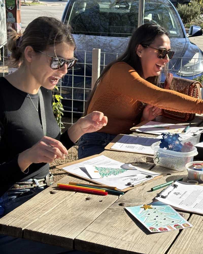 A volunteer making a handmade card at an HBH popup event.