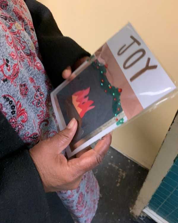 Margaret, a resident, holding a handmade card
